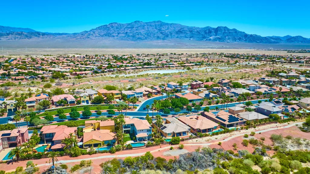 Aerial view of a residential neighborhood in Las Vegas, with desert and mountains in the background.