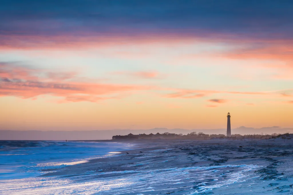 A lighthouse in the distance on the shores of Cape May, NJ.