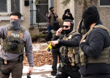 ICE Goon Shoots Bed in Neighboring Hotel Room While Fiddling With His Gun