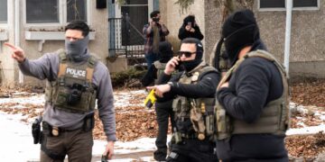 ICE Goon Shoots Bed in Neighboring Hotel Room While Fiddling With His Gun