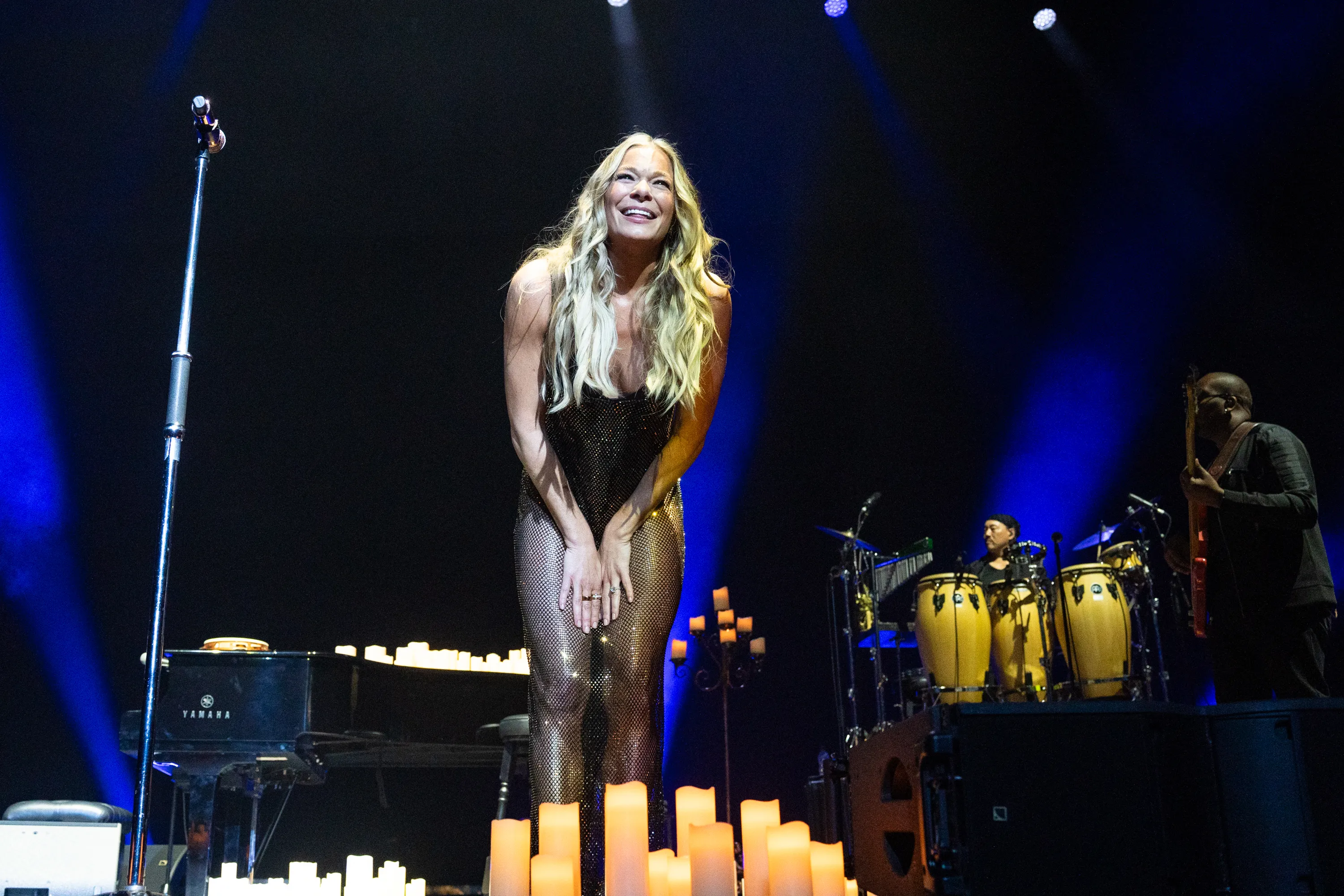LeAnn Rimes smiles while performing on stage.