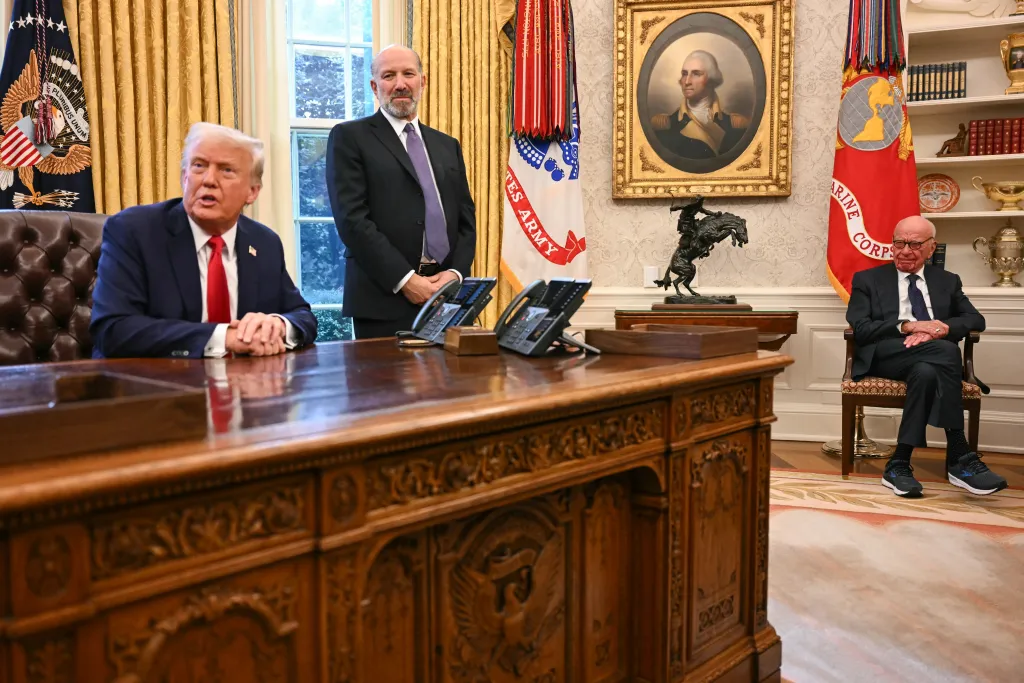 Donald Trump, alongside Secretary of Commerce nominee Howard Lutnick (C) and Rupert Murdoch