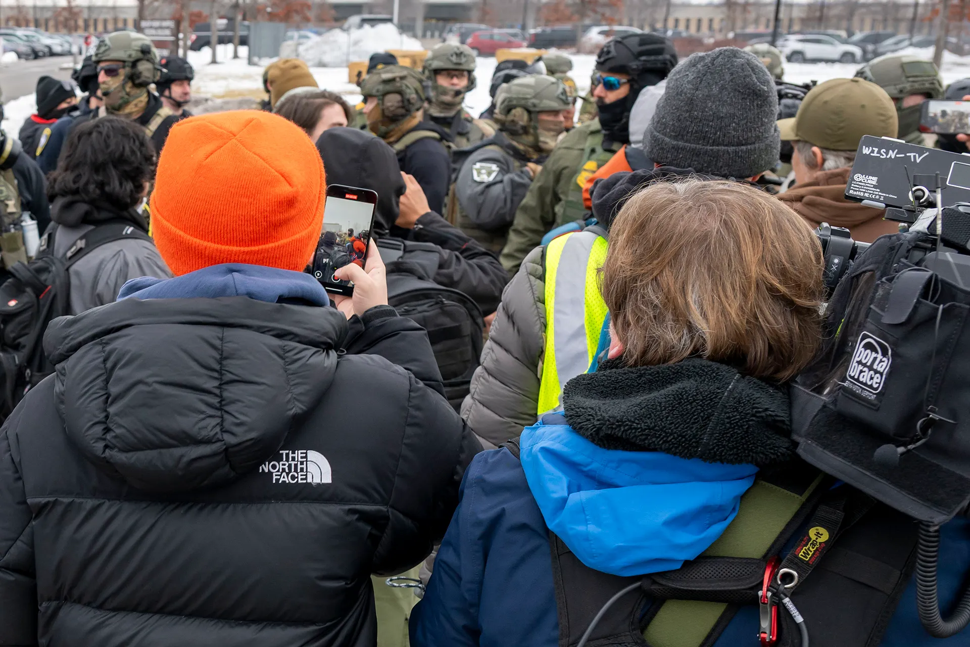 Protesters film ICE agents on with smartphones and cameras Protesters film ICE agents on with smartphones and cameras
