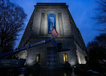 Trump banner on Justice Dept. building draws authoritarian comparisons