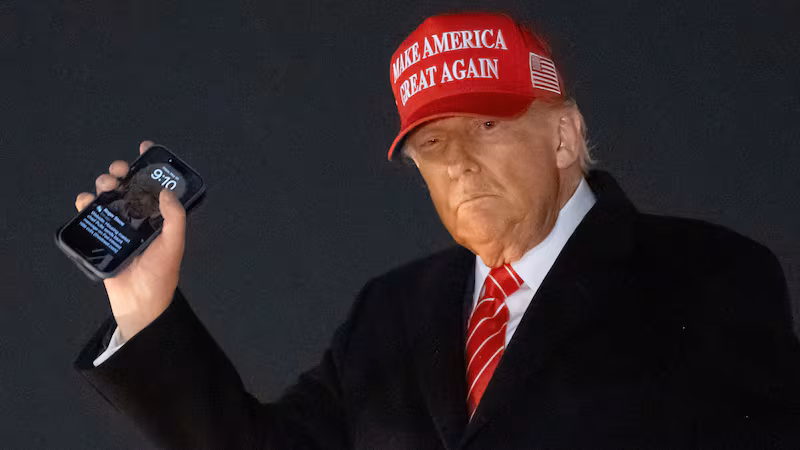 US President Donald Trump disembarks from Air Force One while holding his cellphone at Joint Base Andrews in Maryland, May 30, 2025.