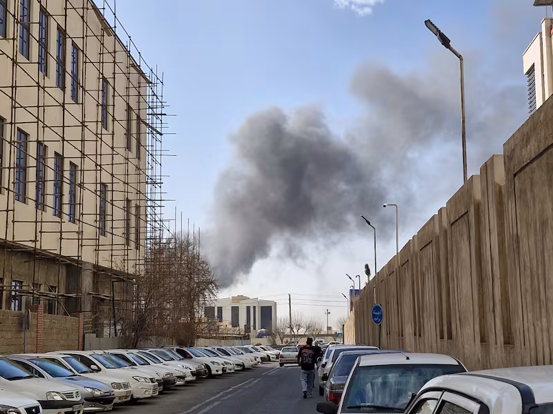 A plume of smoke rises over Tehran after a reported explosion on February 28, 2026, after Israel said it carried out a "preemptive strike" on Iran as sirens sounded in Jerusalem and phone alerts warned of an "extremely serious" threat. (Photo by Ehsan / Middle East Images / AFP via Getty Images)