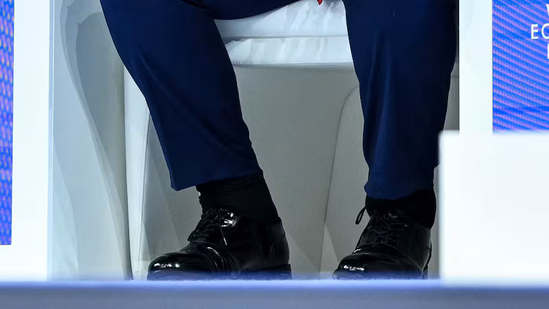 Trump's swollen ankles bulged over his shoes as he spoke with World Economic Forum CEO Borge Brende.