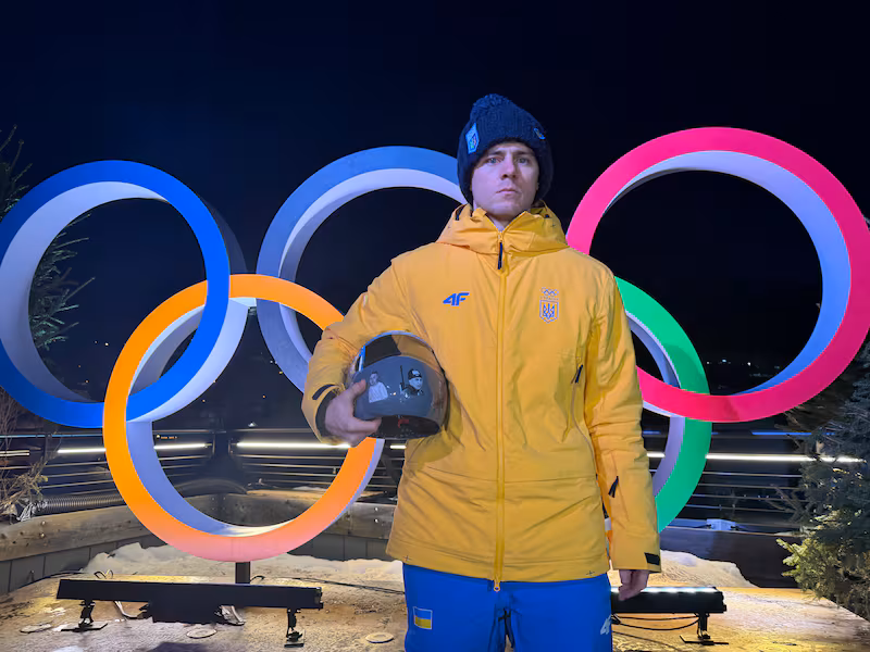 TOPSHOT - Vladyslav Heraskevych of Ukraine poses with his helmet that serves as a tribute to athletes who have died amid Russia's attack on Ukraine during a press conference in Cortina d'Ampezzo as part of Milano Cortina 2026 Olympic Games, on February 10, 2026. Ukrainian skeleton racer Vladyslav Heraskevych vowed that he would wear his helmet 