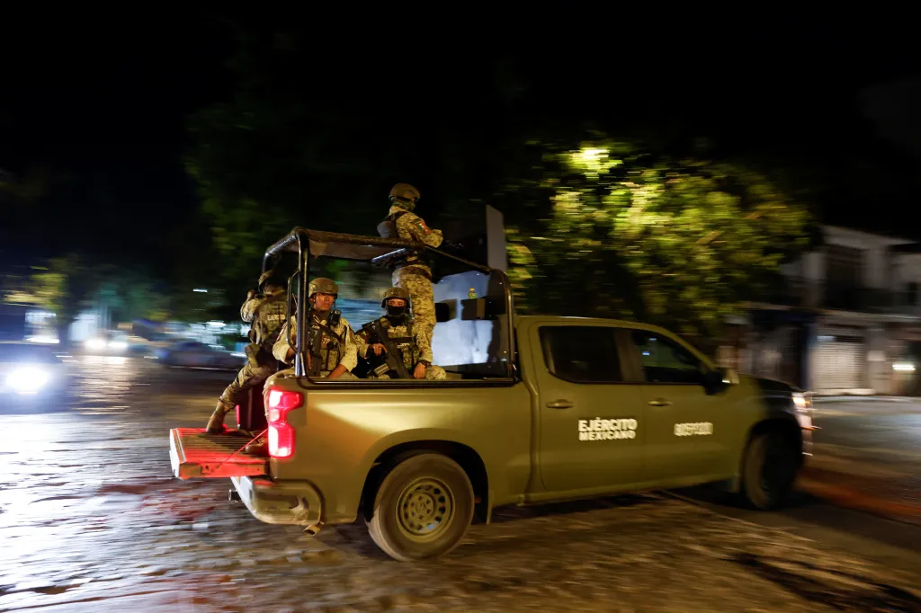 Soldiers patrol on a street in a tourist area a day after a series of blockades and attacks by organized crime following a military operation in which cartel boss Nemesio Oseguera,