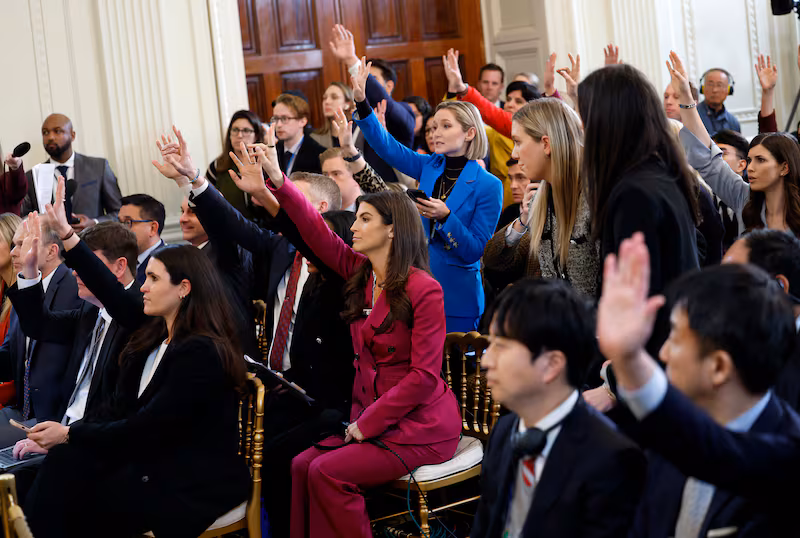 Journalist and CNN news anchor Kaitlan Collins and other journalist raise their hands during a joint press conference between U.S. President Donald Trump and Japanese Prime Minister Shigeru Ishiba in the East Room at the White House on February 07, 2025 in Washington, DC.