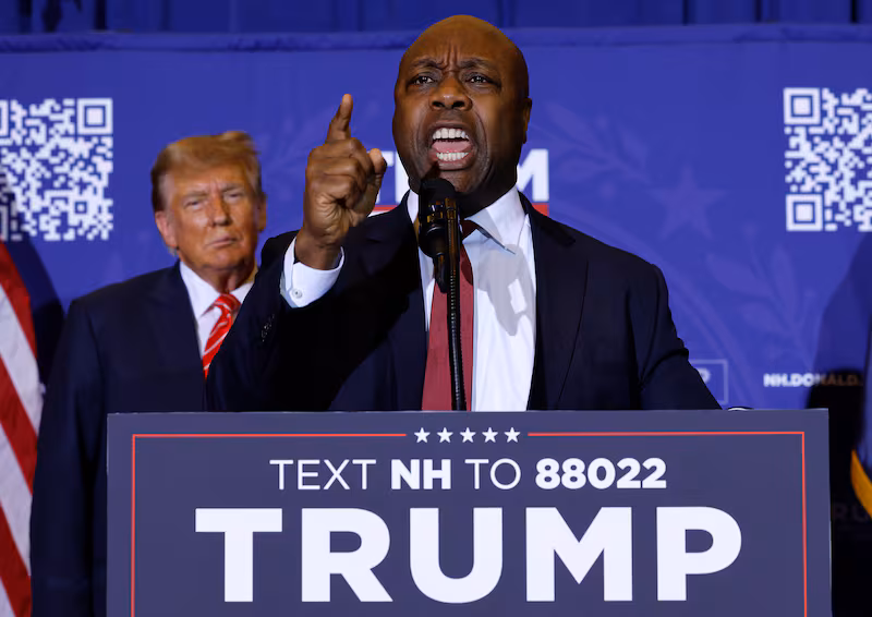 Sen. Tim Scott speaks as President Donald Trump looks on during a campaign rally at the Grappone Convention Center on January 19, 2024 in Concord, New Hampshire