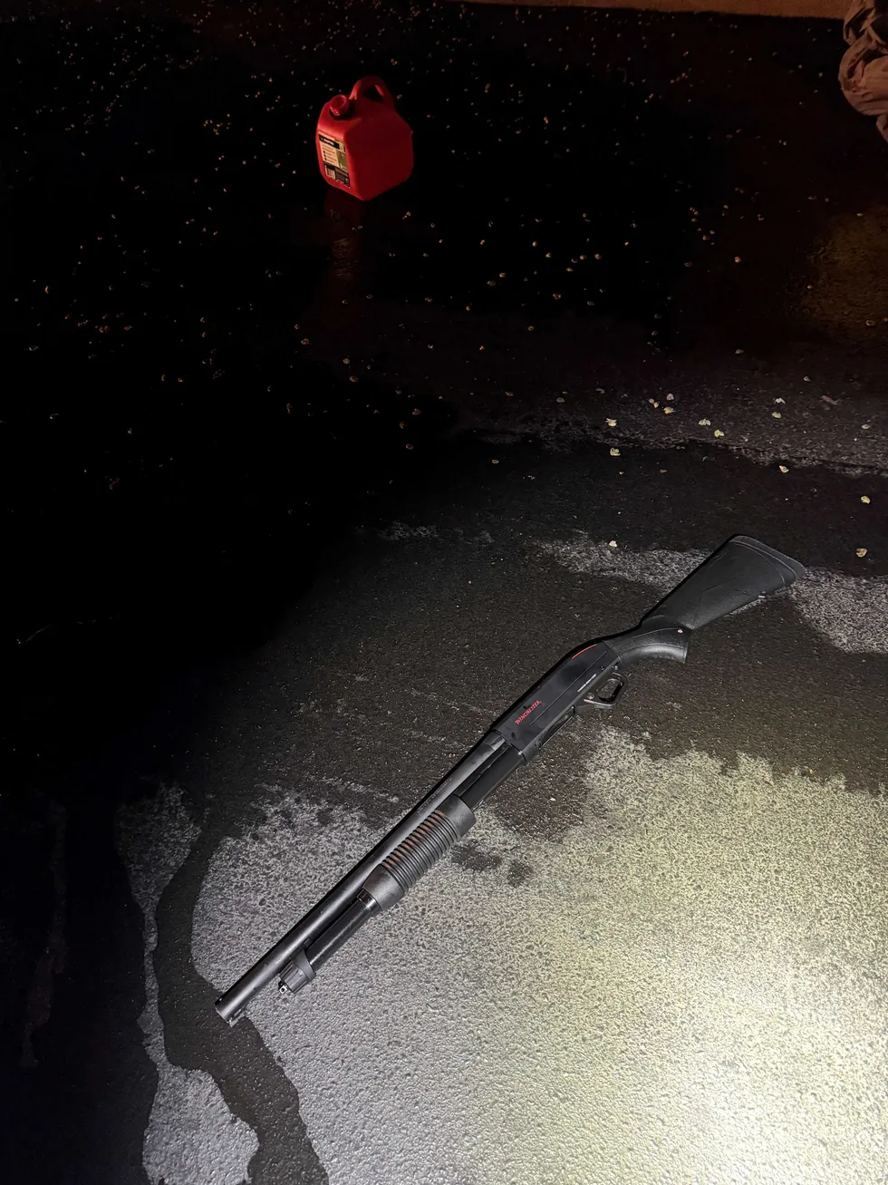 A shotgun and a gasoline canister