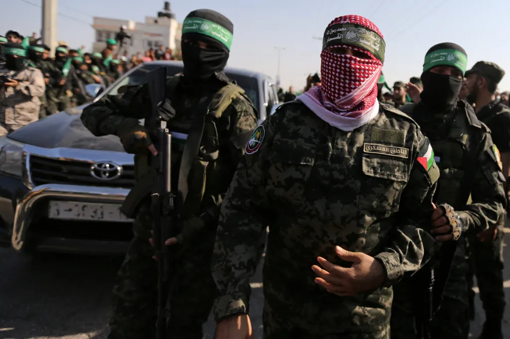Hamas spokesman Abu Ubaida in camouflage with other militants during an anti-Israel military show.