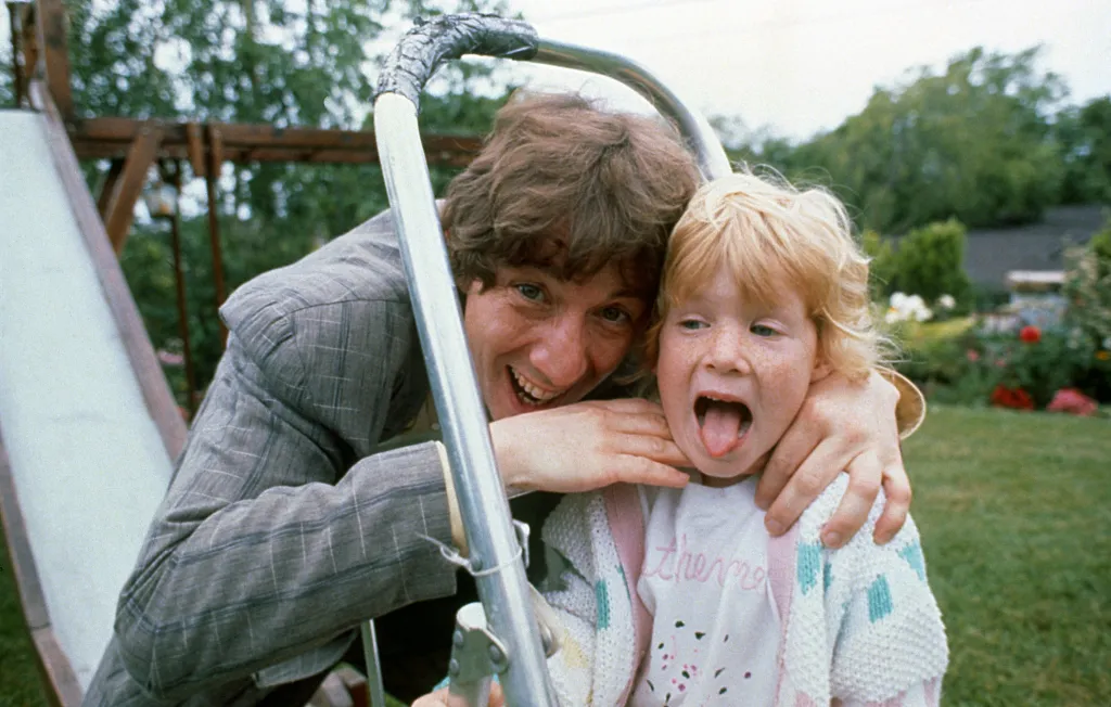 Actor Martin Short with his arm around his daughter Katherine, who sticks out her tongue.