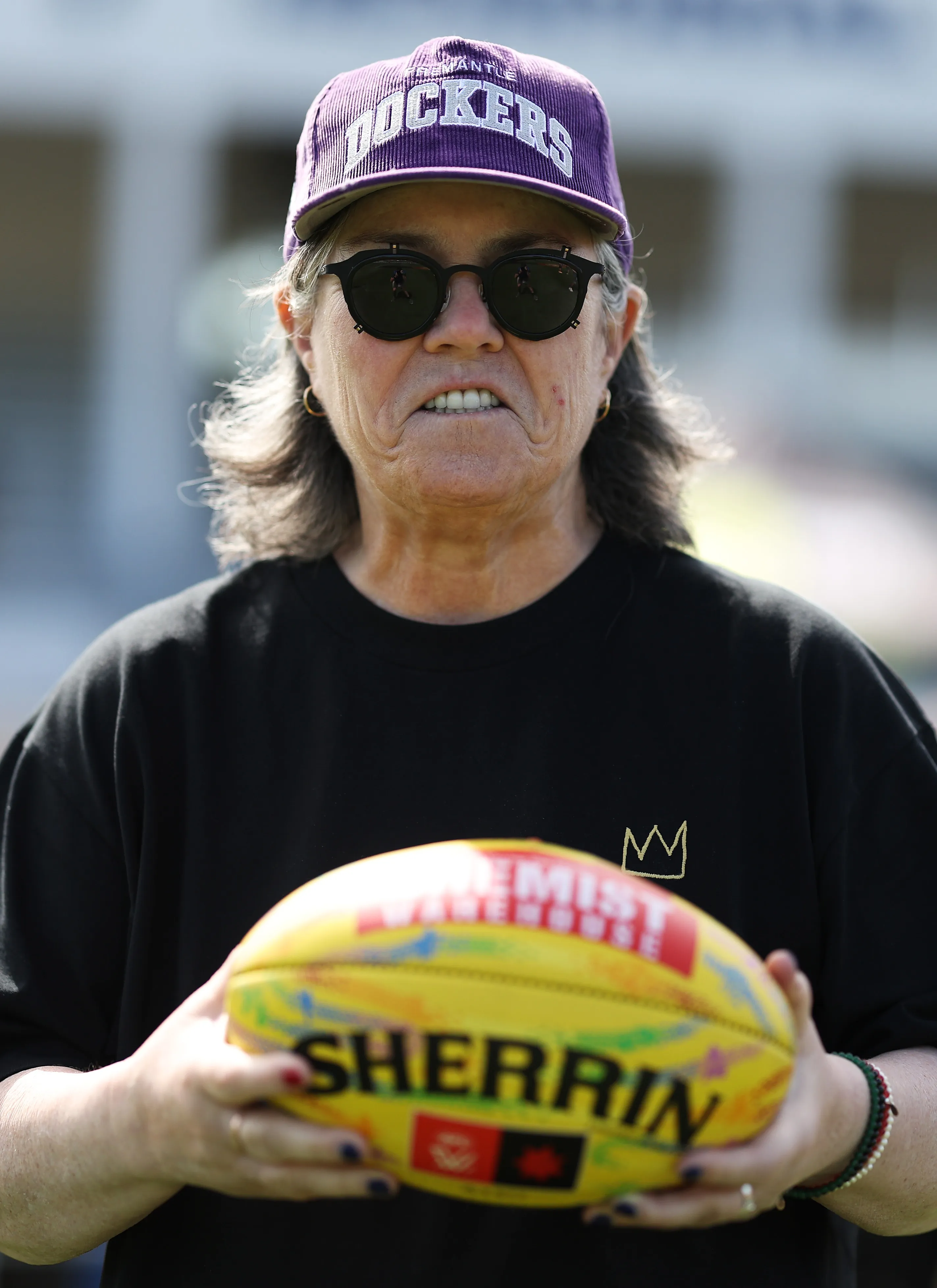 Actor and comedian Rosie O'Donnell poses with an Australian rules football.