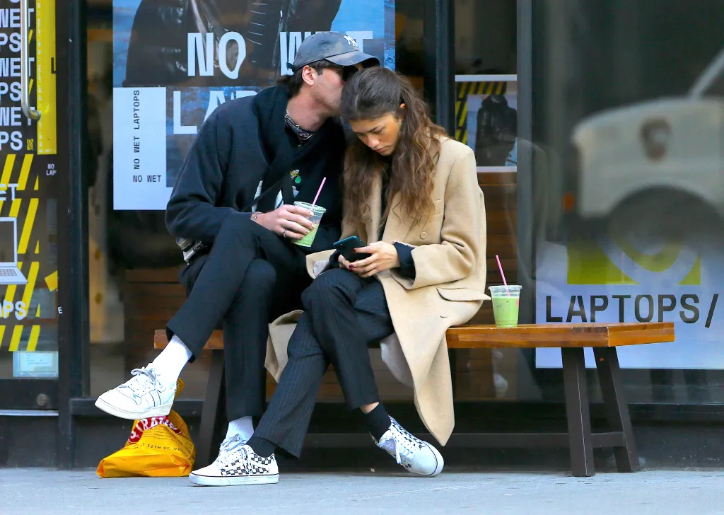 Zendaya and Jacob Elordi sitting on a bench with matcha smoothies.