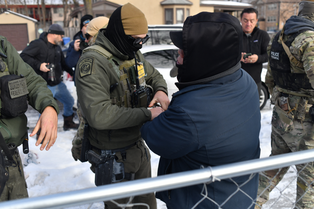 US Customs and Border Protection agent arresting a man in Minneapolis, Minnesota.