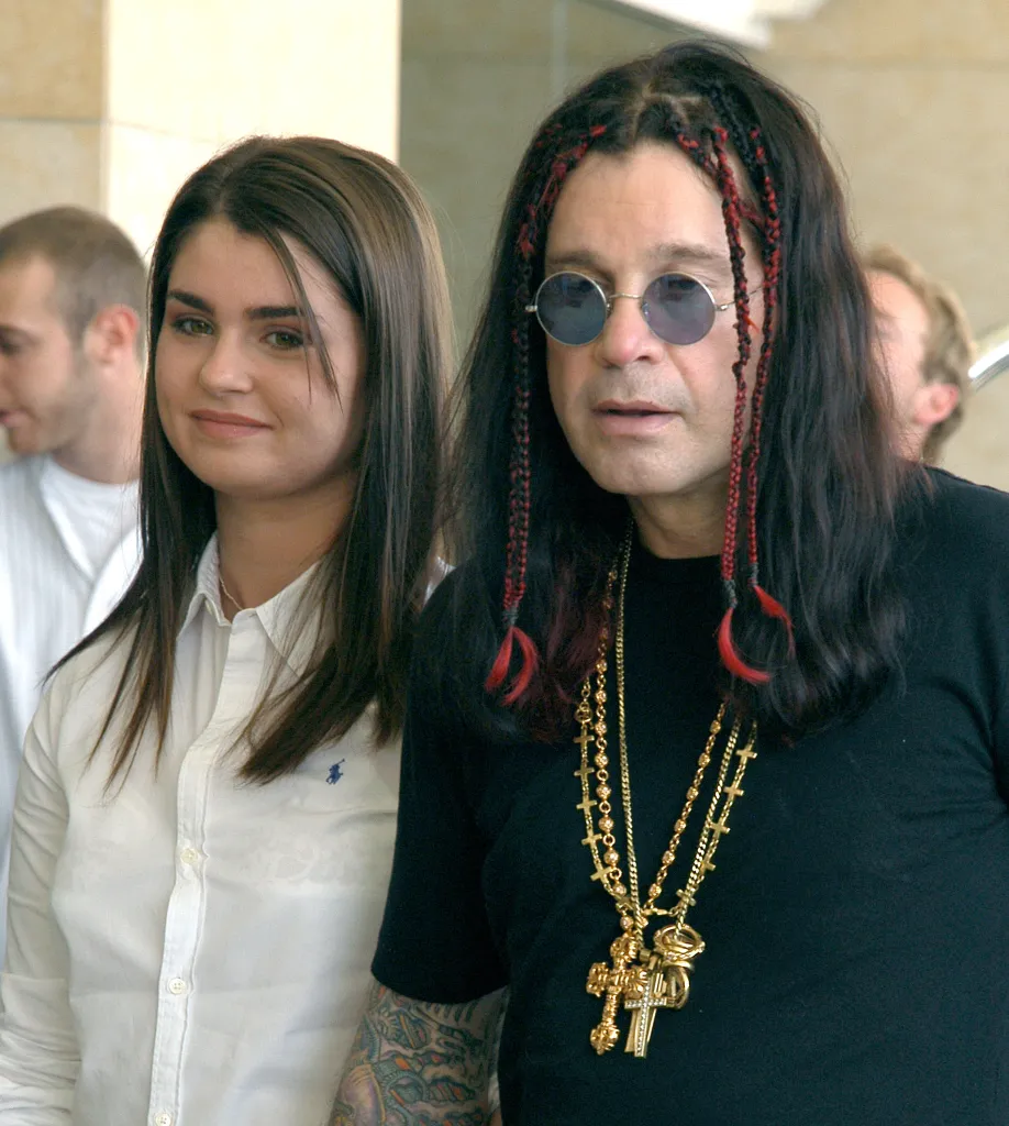 Aimee Osbourne and Ozzy Osbourne pose together.