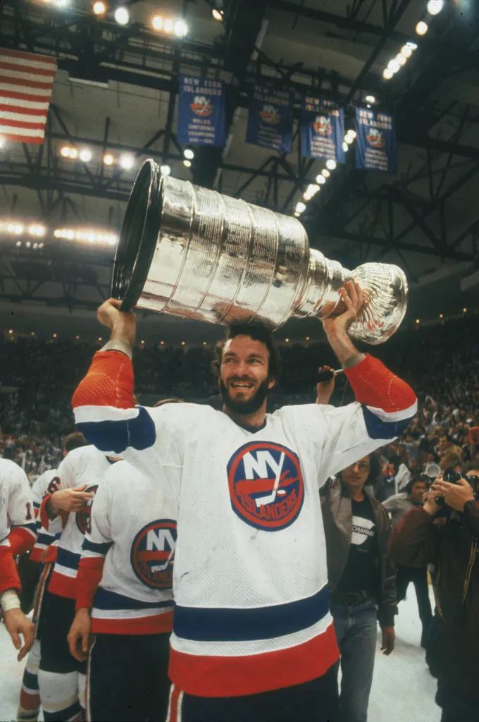 Ken Morrow of the New York Islanders lifts the Stanley Cup over his head after winning the NHL championship.