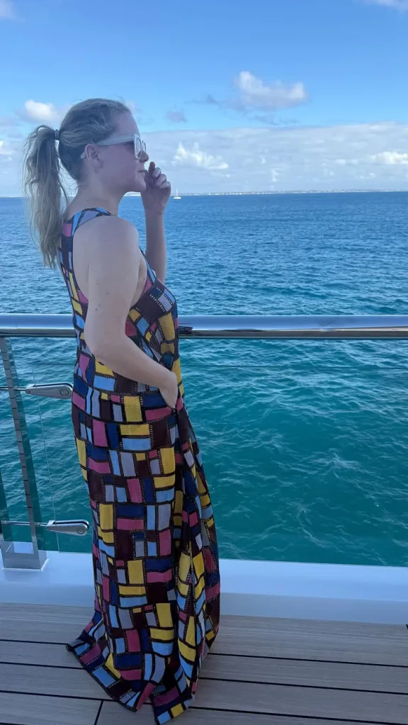 Amy Schumer in a colorful dress on a boat.
