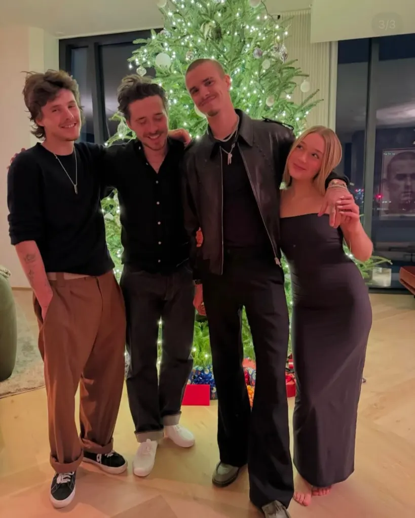 Cruz, Brooklyn, Romeo, and Harper Beckham posing in front of a Christmas tree.