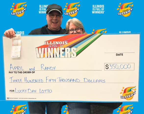 April and Randy holding a ceremonial check for $350,000 from the Illinois Lottery.
