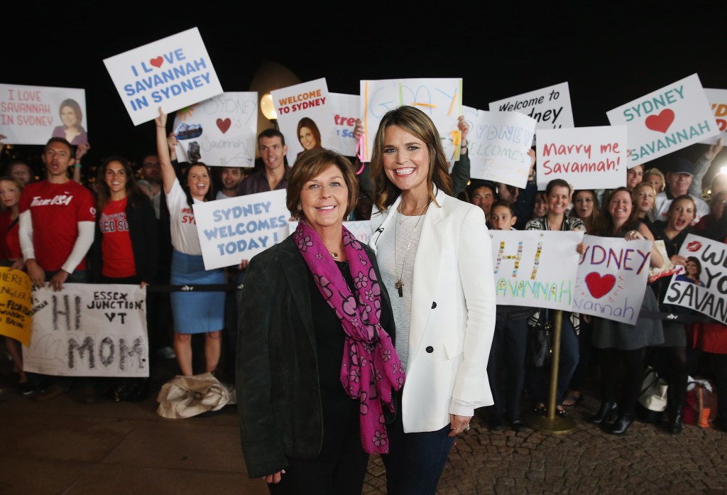 Savannah Guthrie and her mother Nancy Guthrie posing with fans holding signs for Savannah and the 