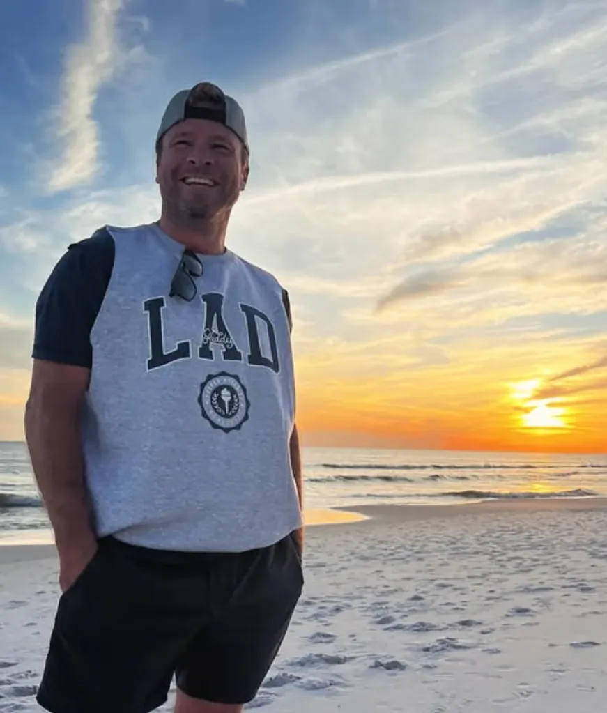 Backstreet Boy Brian Littrell on a beach at sunset.