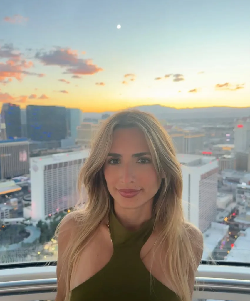 Carliz De La Cruz Hernández with a city skyline at sunset in the background.