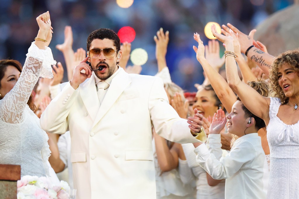 Bad Bunny performing at the Super Bowl 60 halftime show, surrounded by backup performers in white.
