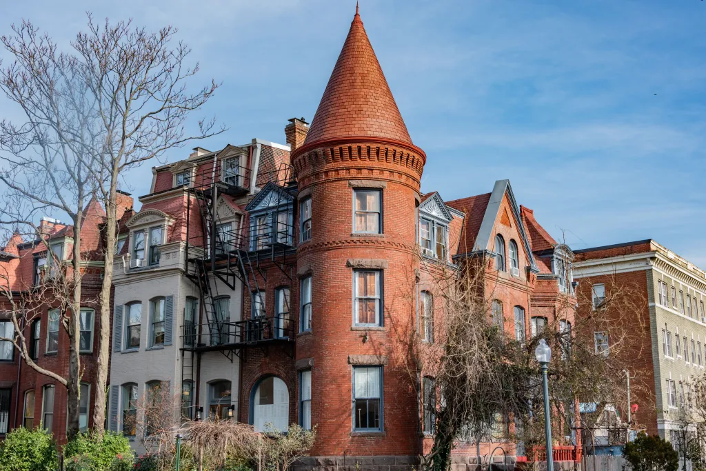 A row of brick apartment buildings in Dupont Circle, Washington D.C., including one with a conical turret.