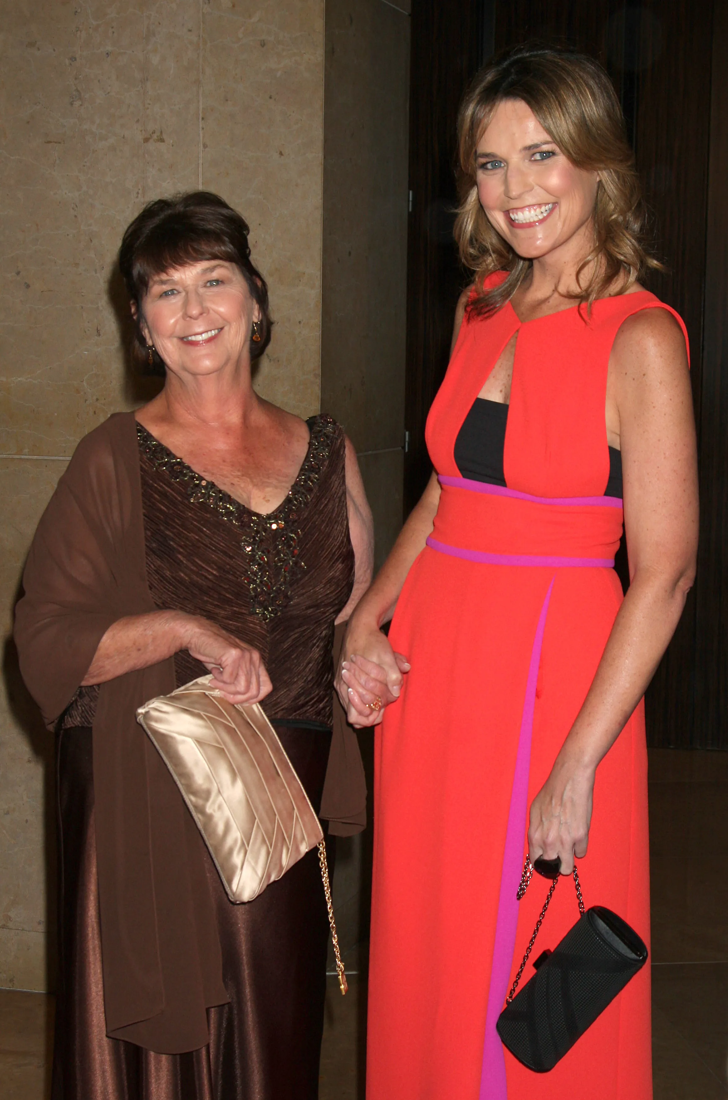 Nancy Guthrie and Savannah Guthrie smiling and holding hands.