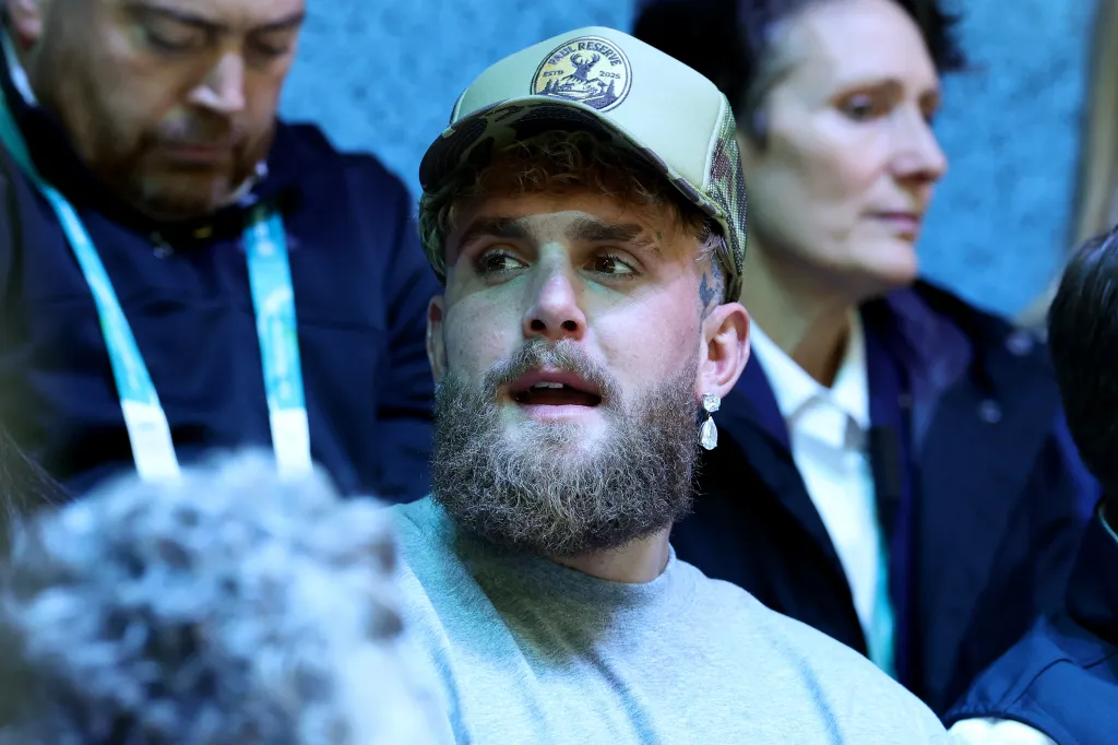 Jake Paul watching an Olympic ice hockey match.