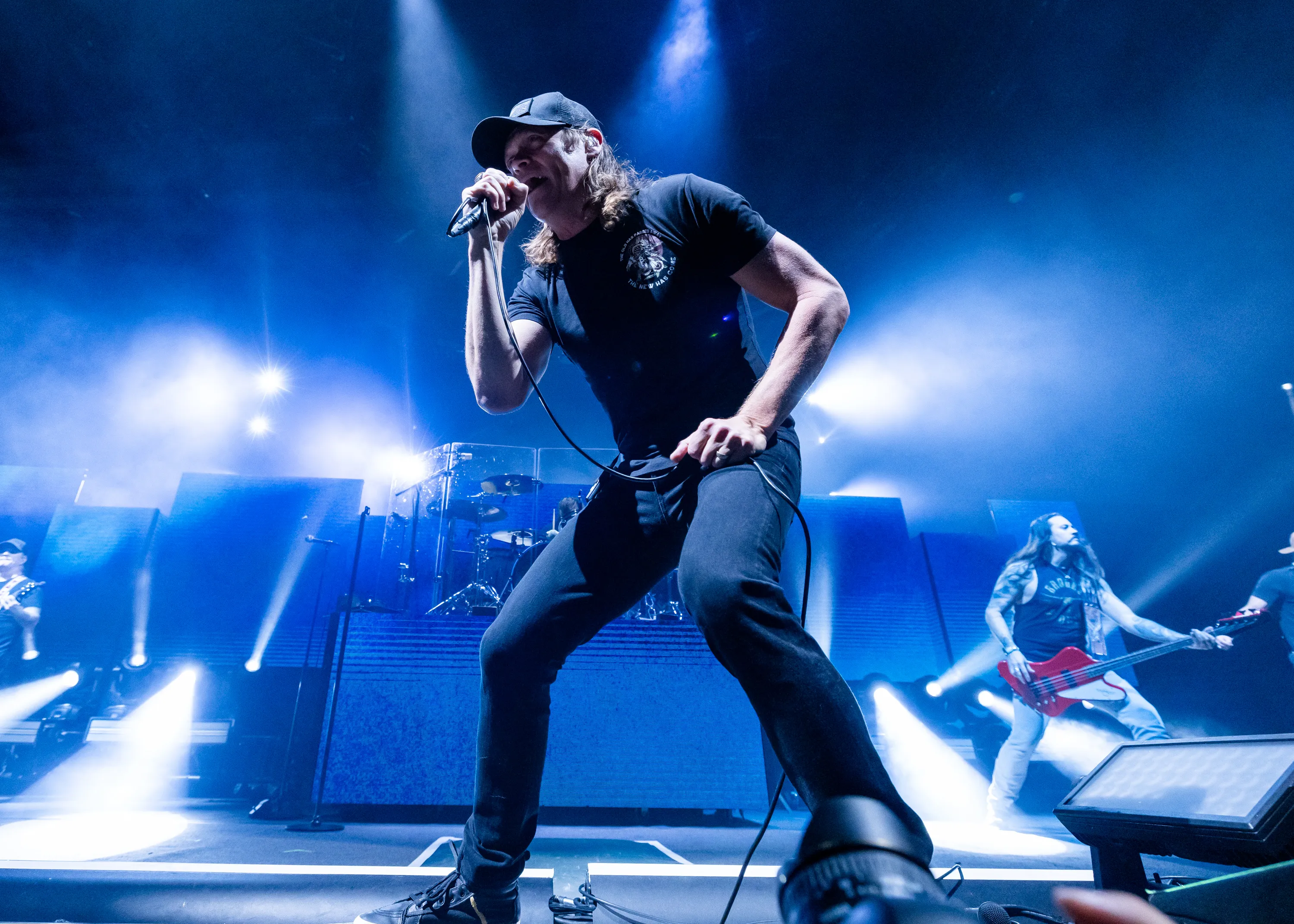 Brad Arnold of 3 Doors Down performing on stage, singing into a microphone.