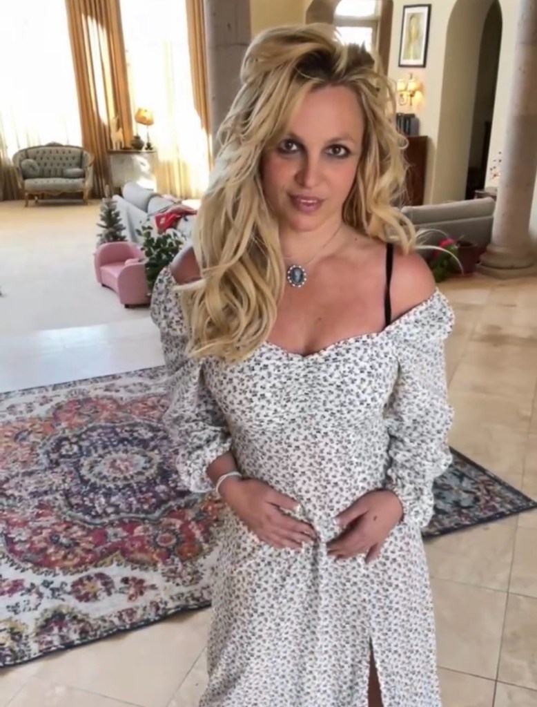 Britney Spears posing in a floral dress.