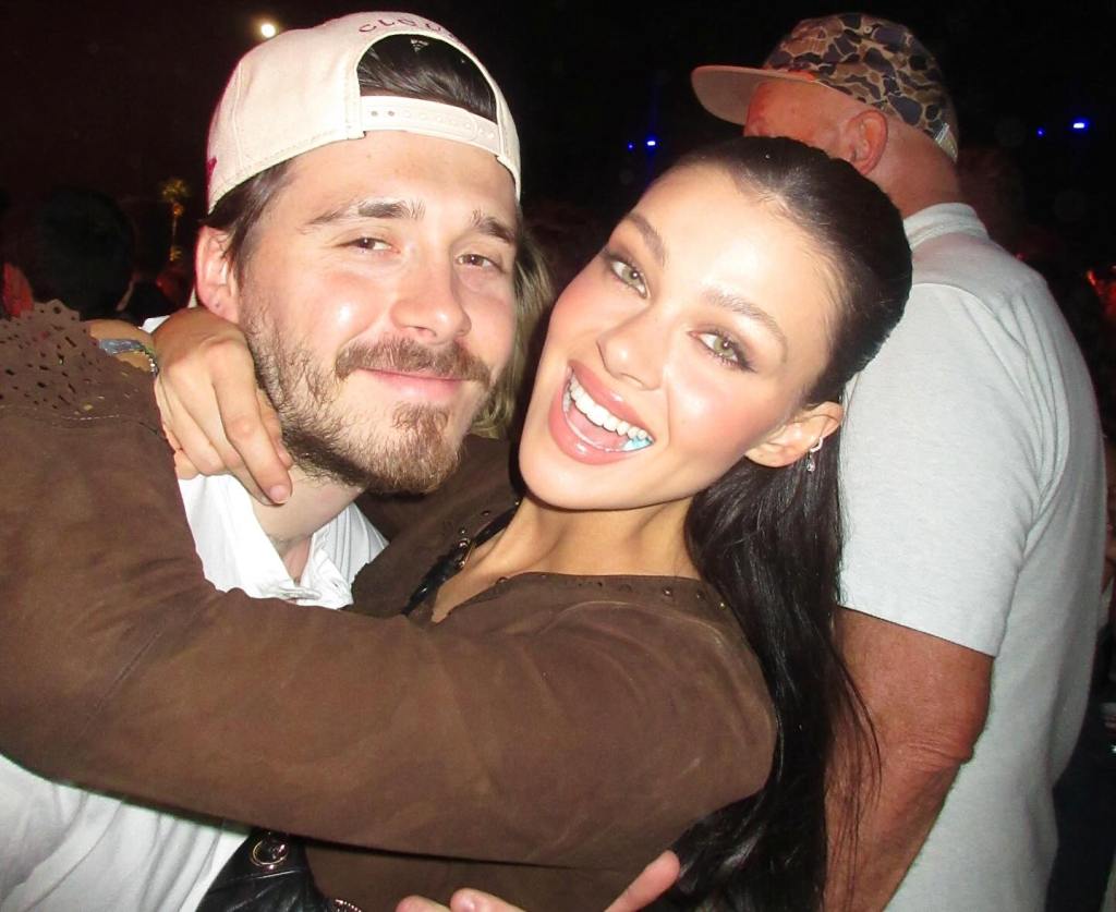 Brooklyn Beckham and Nicola Peltz embrace.