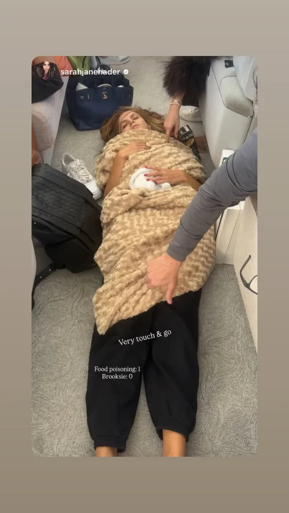 Brooks Nader lying on the floor of a plane, covered in a blanket, with text overlay indicating food poisoning.