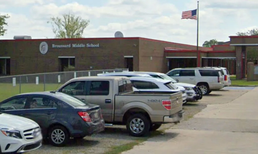 Broussard Middle School building with a parking lot in front.