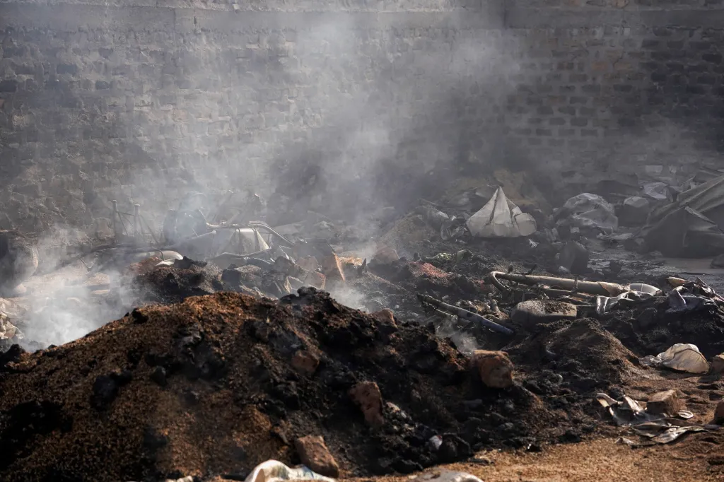 Burnt grains and farming equipment sit inside a storehouse following a deadly gunmen attack in Yelwata, Benue State, Nigeria.