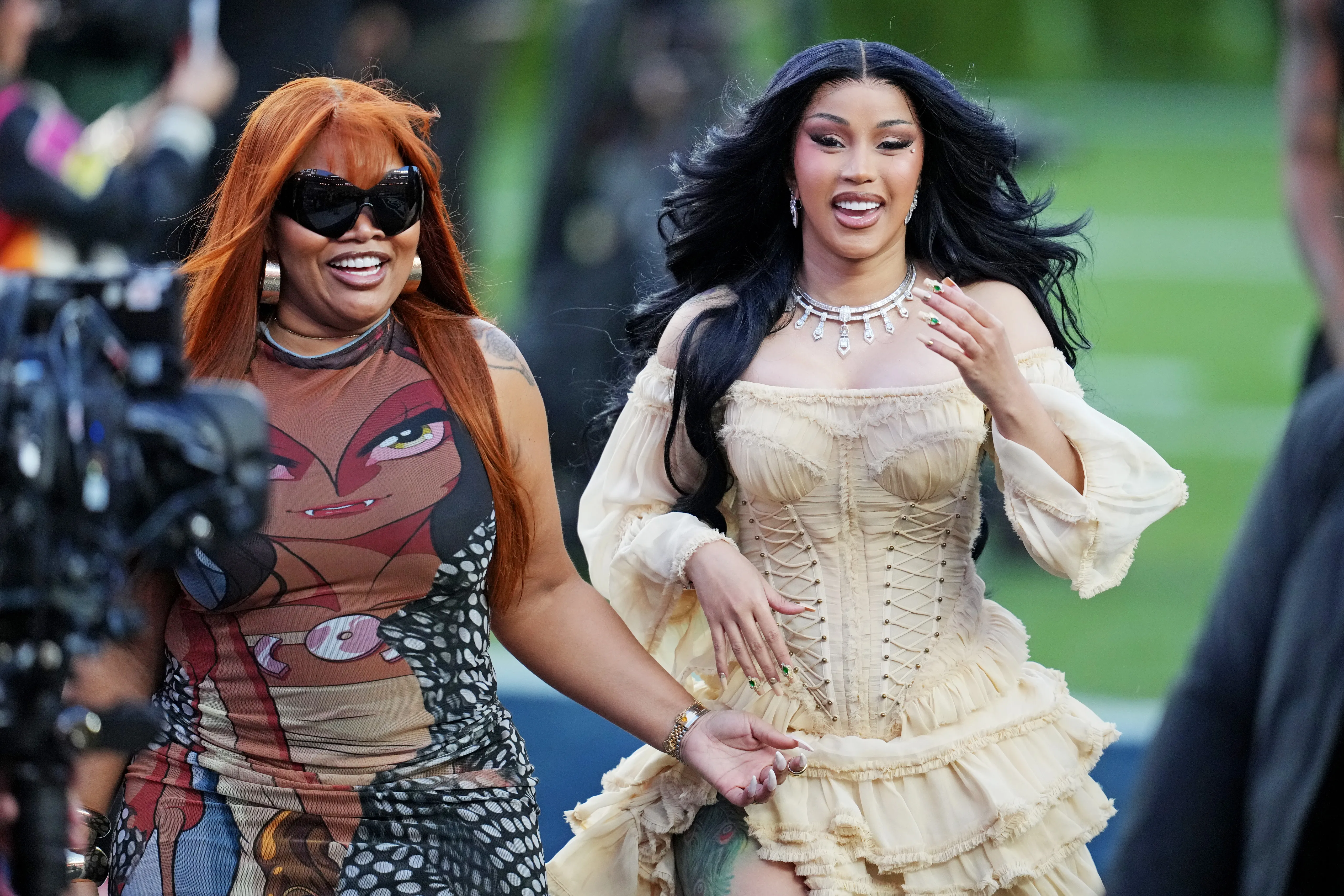 Cardi B wearing a cream-colored dress arriving at the Super Bowl LX halftime show.