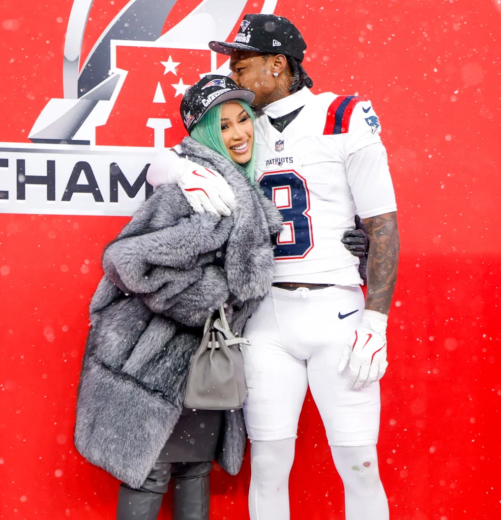 Cardi B in a fur coat with Stefon Diggs in a New England Patriots uniform, both wearing Patriots caps, at the AFC Championship.
