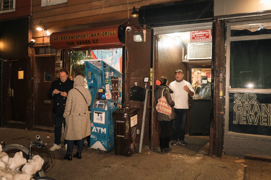 People gathering outside the Caribbean Sport Bar Grill in Williamsburg.
