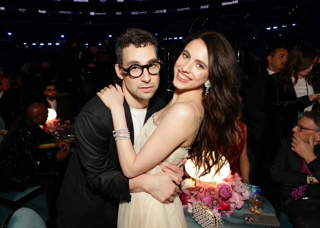 Jack Antonoff and Margaret Qualley smiling and embracing at the 67th Annual Grammy Awards.