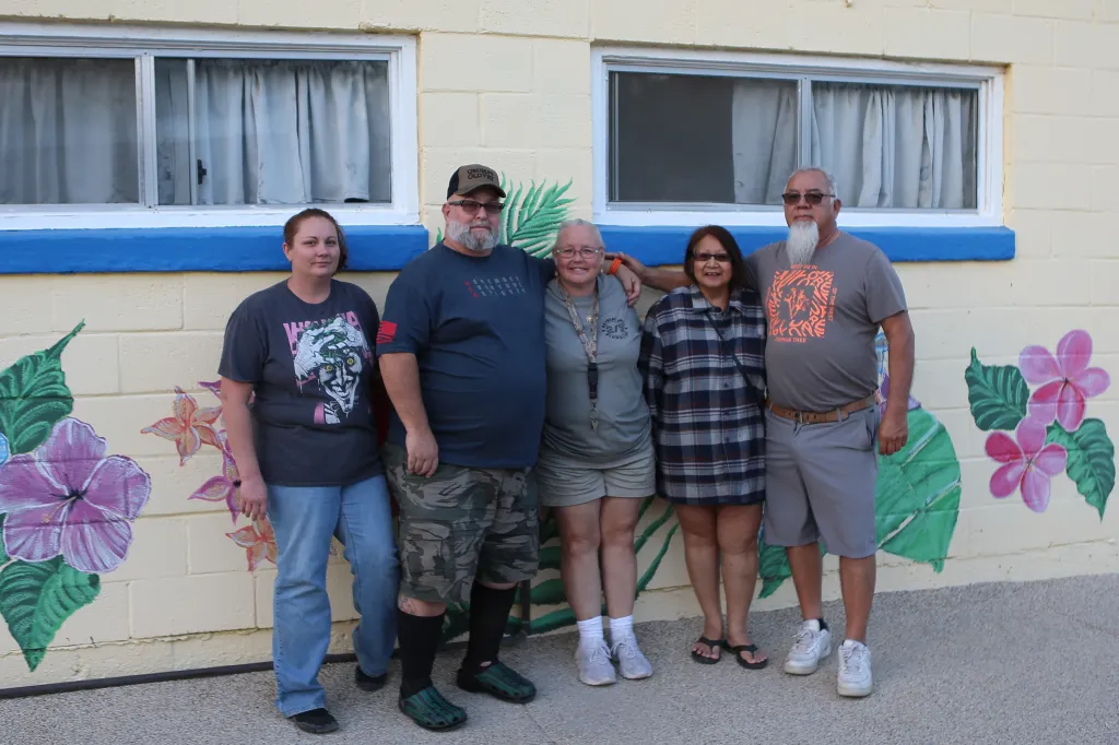 A group of five adults, including Chevy from San Bernardino, standing together at the Redlands Nudist Resort.
