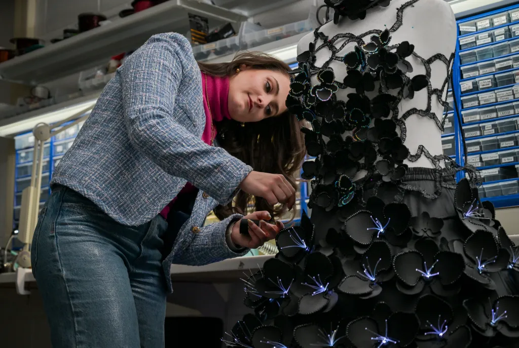 Maia Hirsch adding finishing touches to a robotic dress.