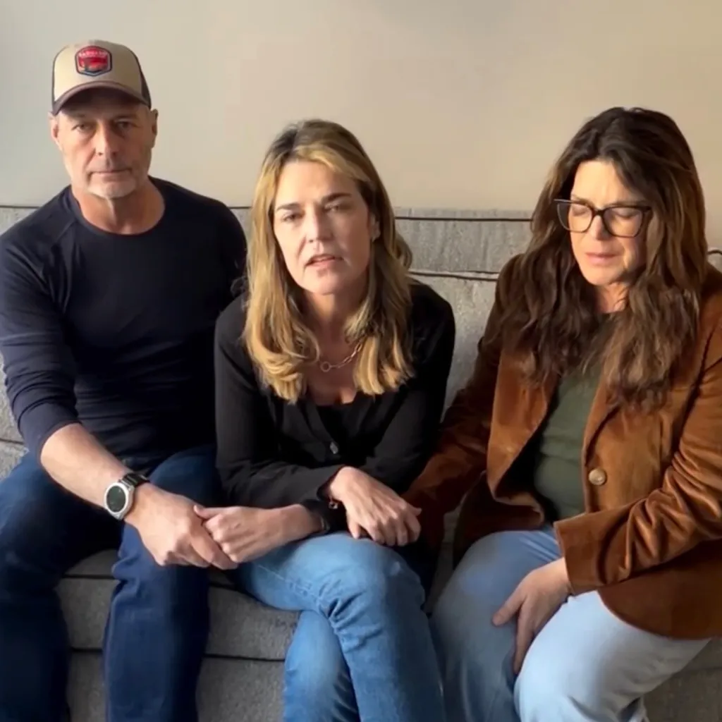 A man and two women sitting on a couch, appearing to be in a video call.