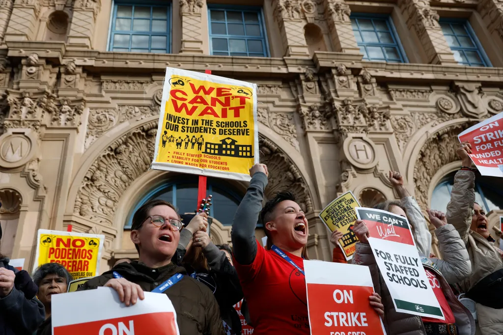 Teachers holding protest signs during a strike in front of Mission High School.