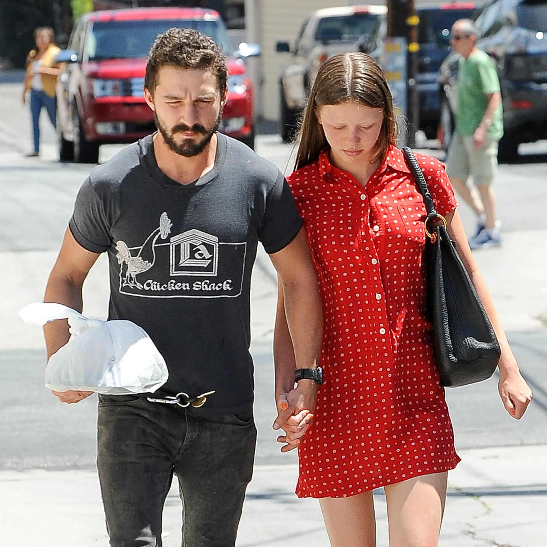 Shia LaBeouf and Mia Goth walk hand-in-hand in Los Angeles in 2014.