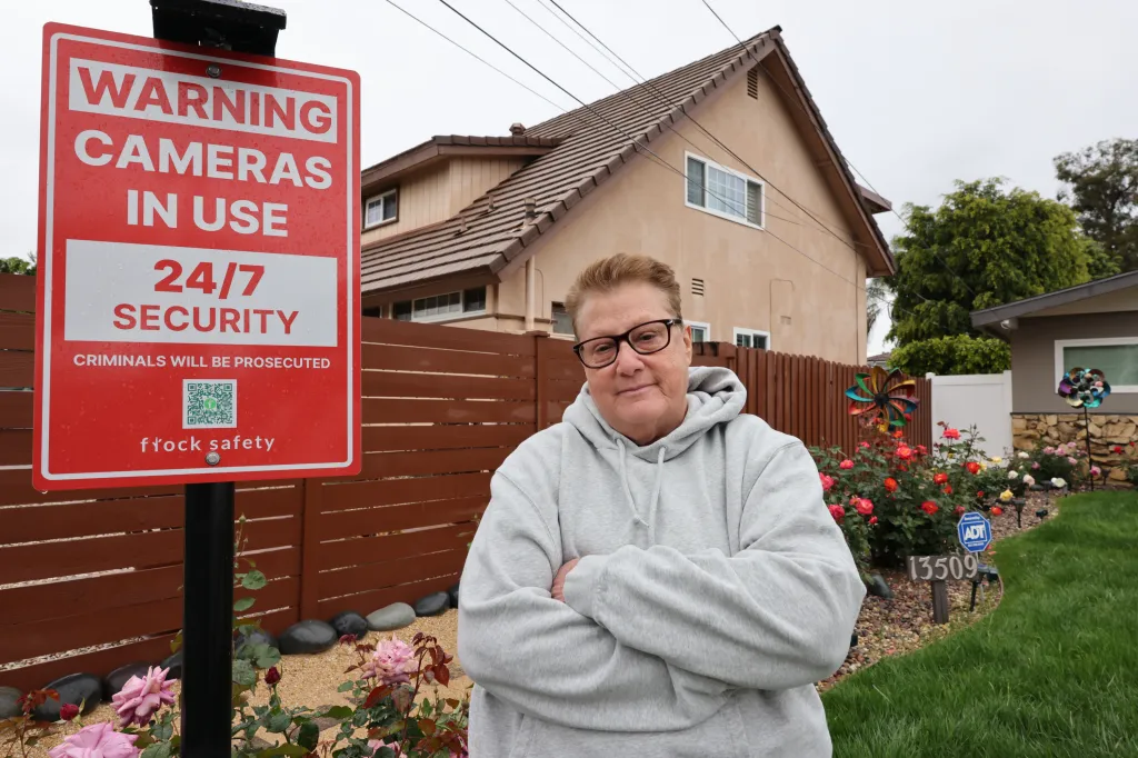 Debbie Stopeck stands in front of a red