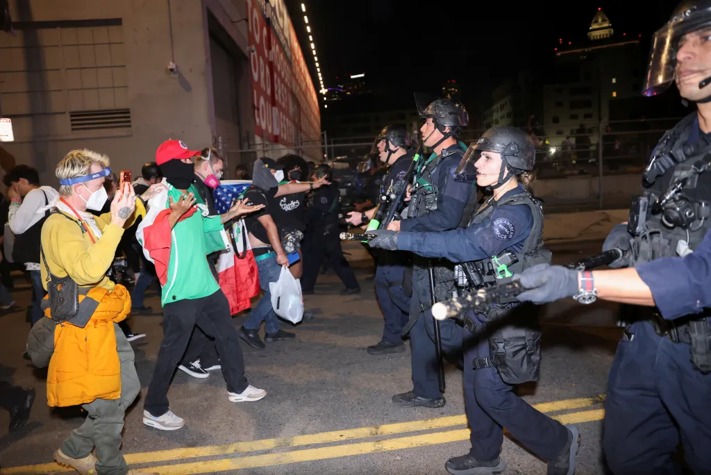 Protesters confronting police at a protest against U.S. immigration policies in Los Angeles.